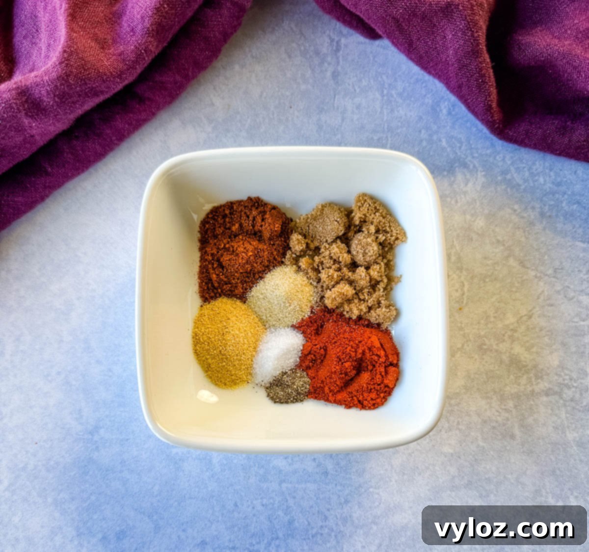 homemade BBQ rub spices in a white bowl, ready for chicken