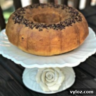 rum bundt cake on a white cake stand