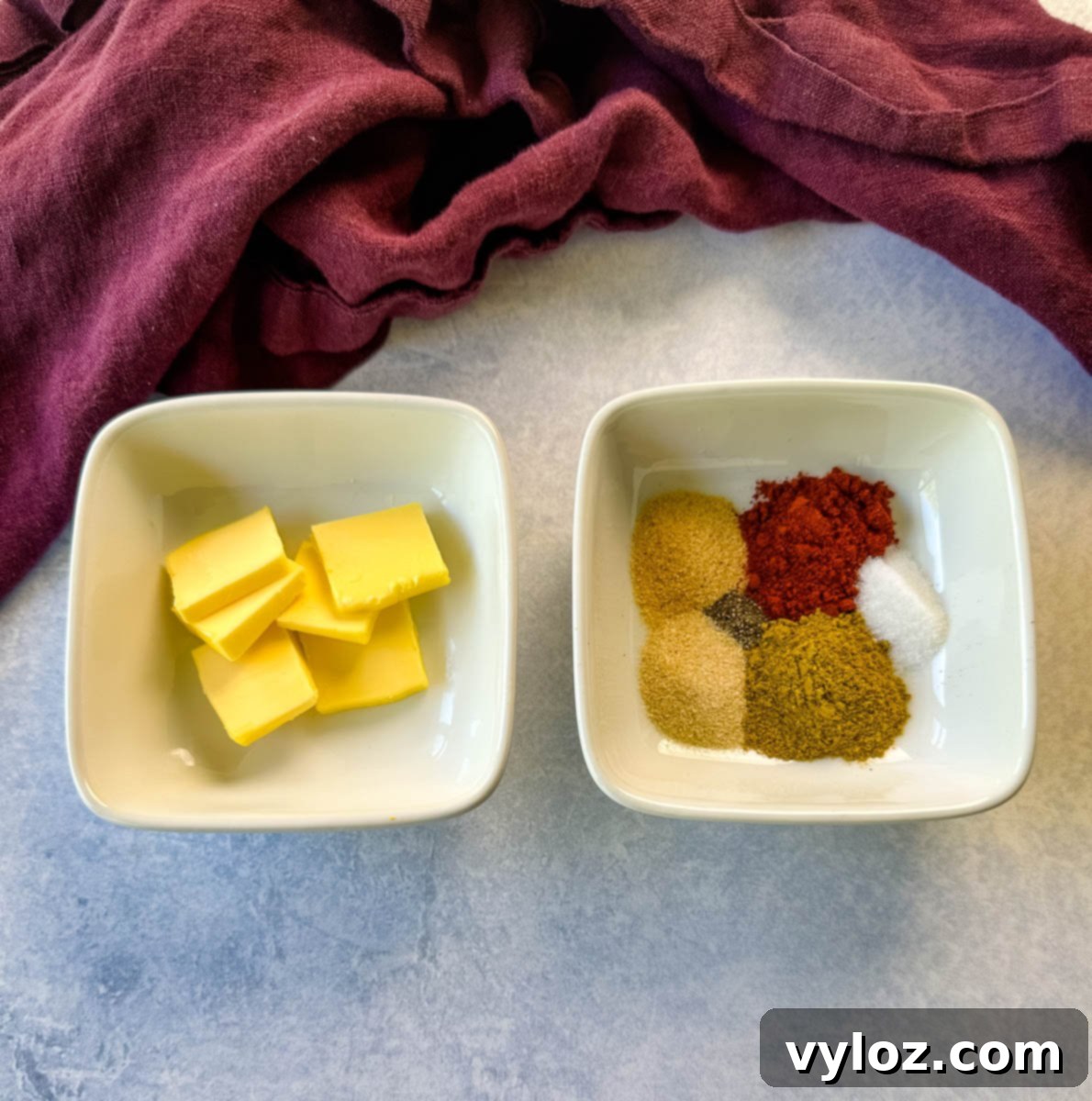 butter and spices in separate white bowls