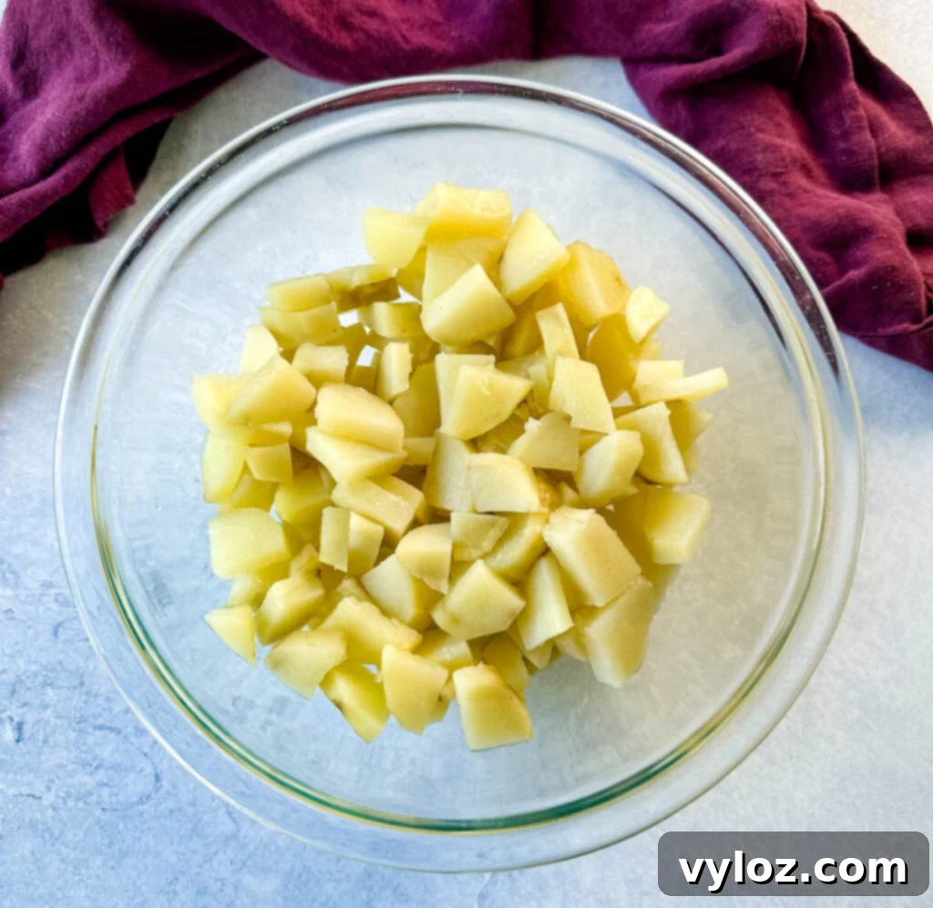 peeled, cooked and diced potatoes in a glass bowl