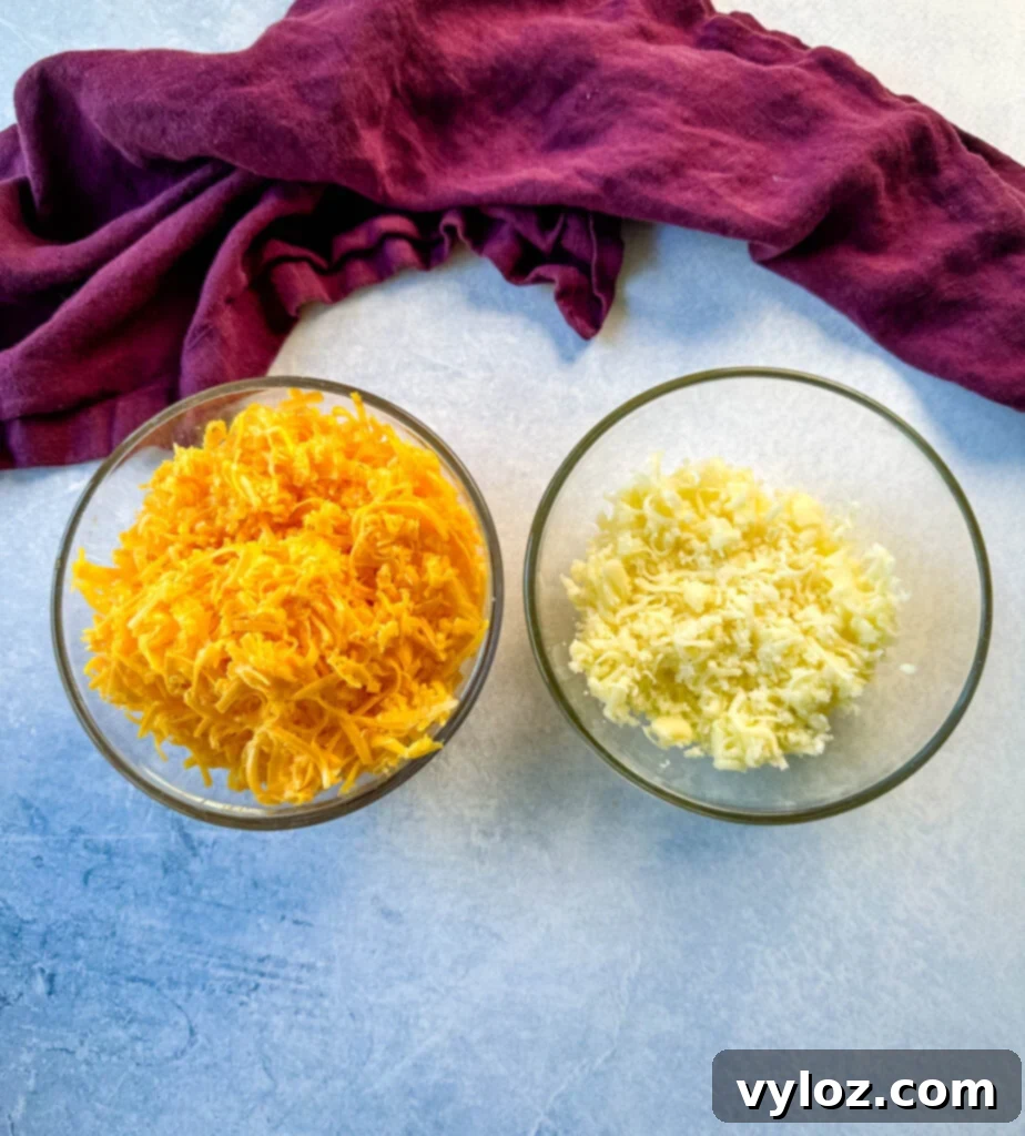 Effortless Crockpot Mac and Cheese 5 shredded cheddar cheese and mozzarella in separate glass bowls