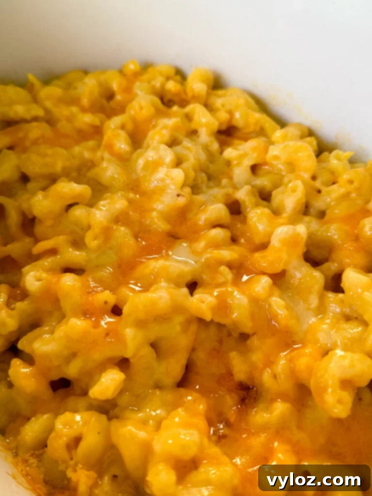Effortless Crockpot Mac and Cheese 7 mac and cheese in a white Crockpot slow cooker