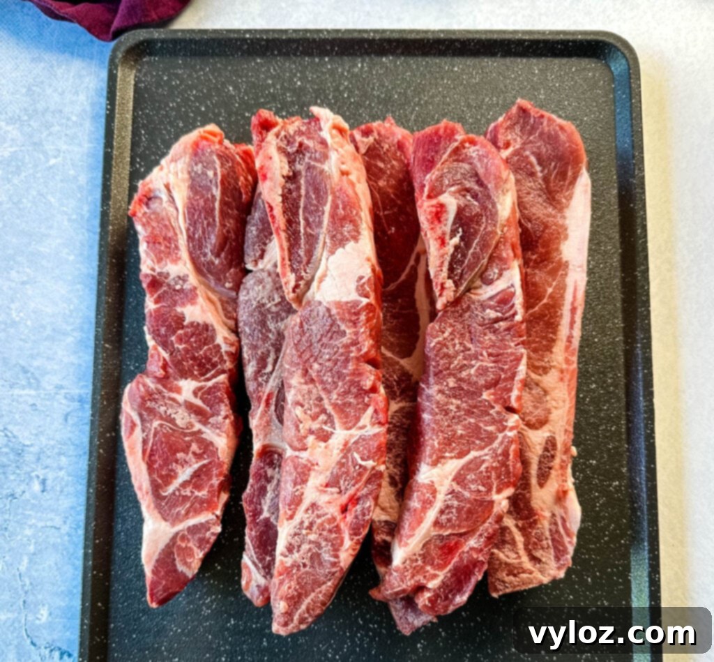 raw country style ribs on a sheet pan