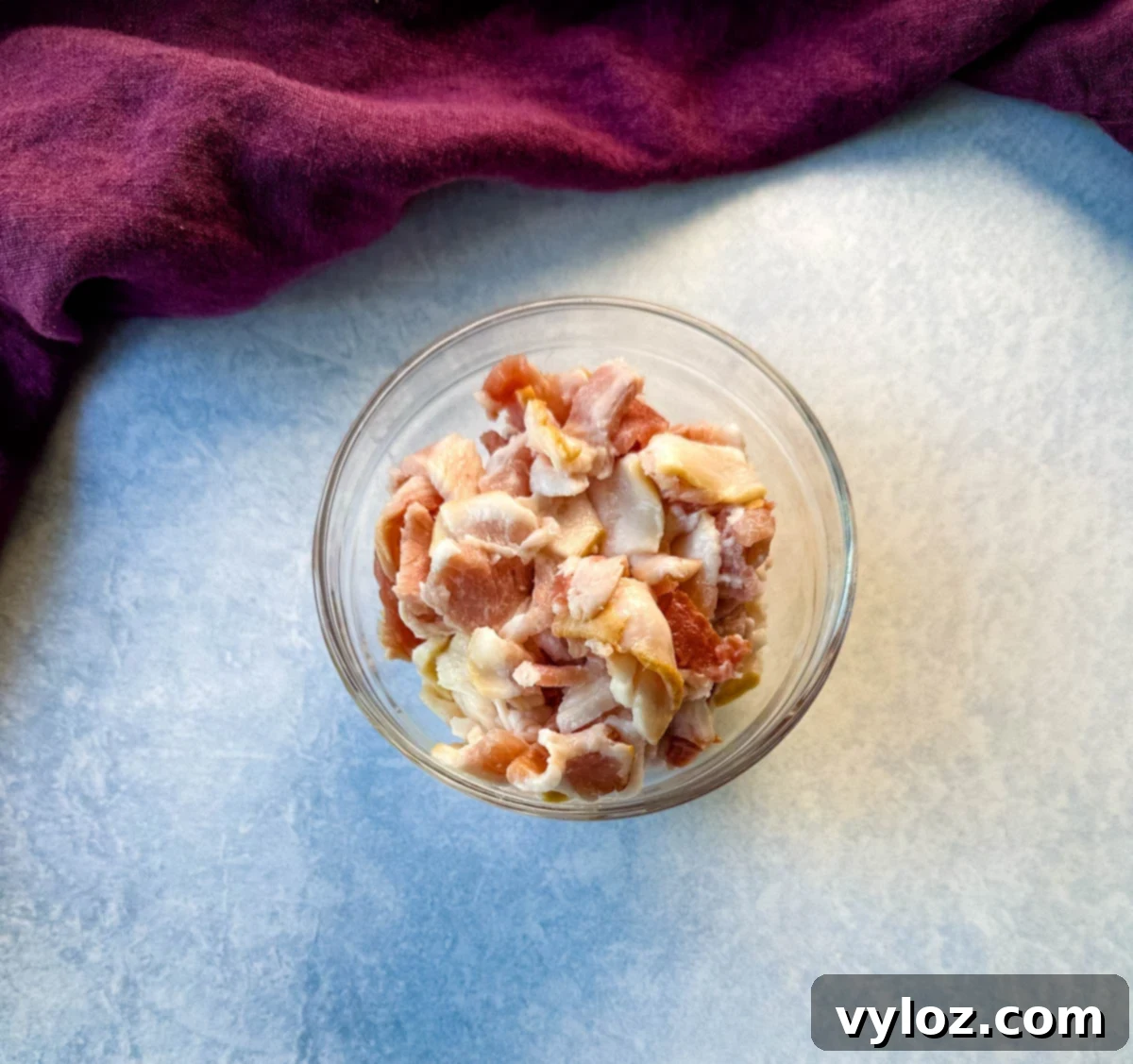 Decadent Bacon and Cheese Potato Gratin 5 uncooked chopped bacon in a glass bowl