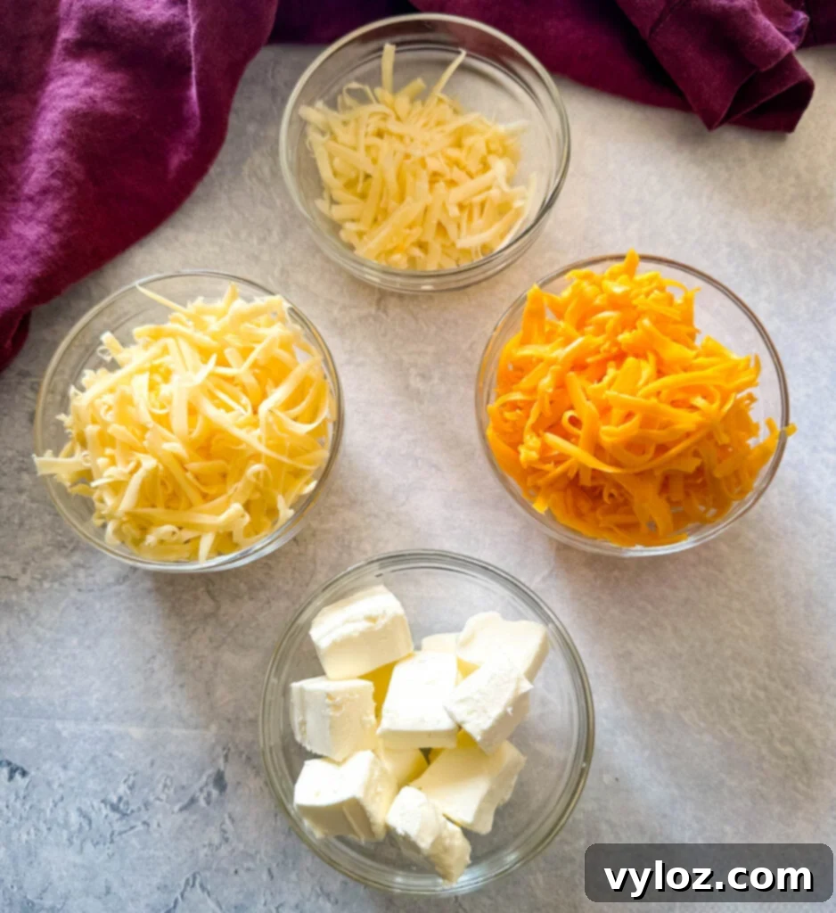 Decadent Bacon and Cheese Potato Gratin 7 shredded cheddar, Gruyere, Parmesan, and cream cheese in separate glass bowls