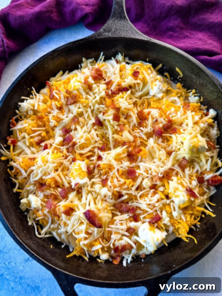 Decadent Bacon and Cheese Potato Gratin 9 unbaked au gratin potatoes with bacon and cheese in a cast iron skillet