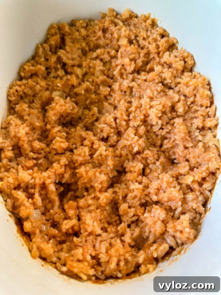cooked Spanish Mexican rice in a white slow cooker Crockpot