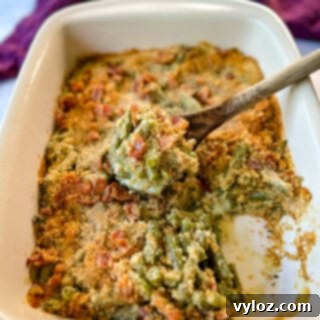 Green bean casserole with bacon and breadcrumbs in a baking dish