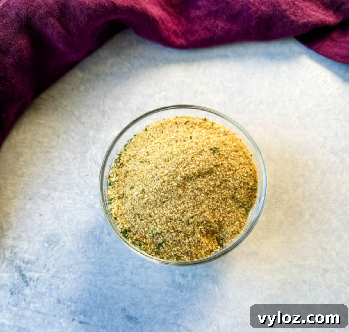 Top-down view of a partially assembled green bean casserole in a baking dish