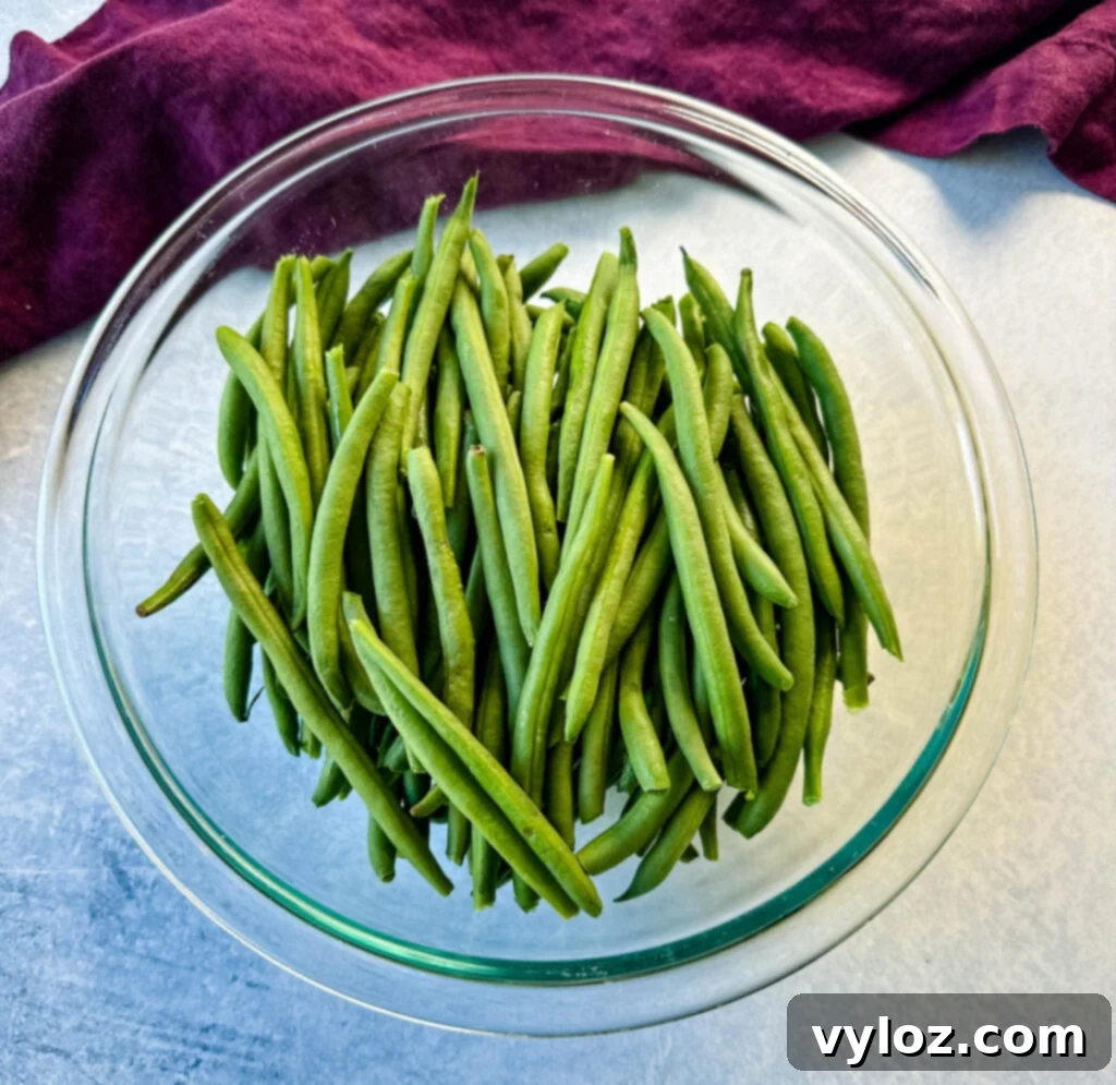 Fresh green beans in a glass bowl, ready for preparation