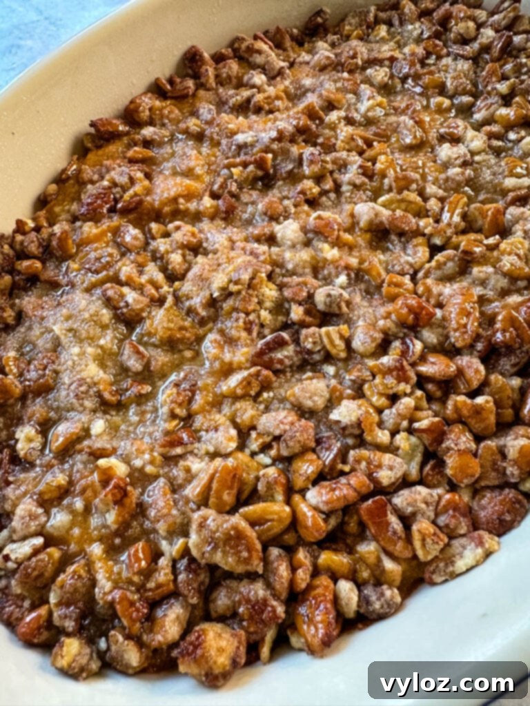 Golden Sweet Potato Pecan Delight 10 Sweet potato casserole with pecan topping in a baking dish, freshly baked.