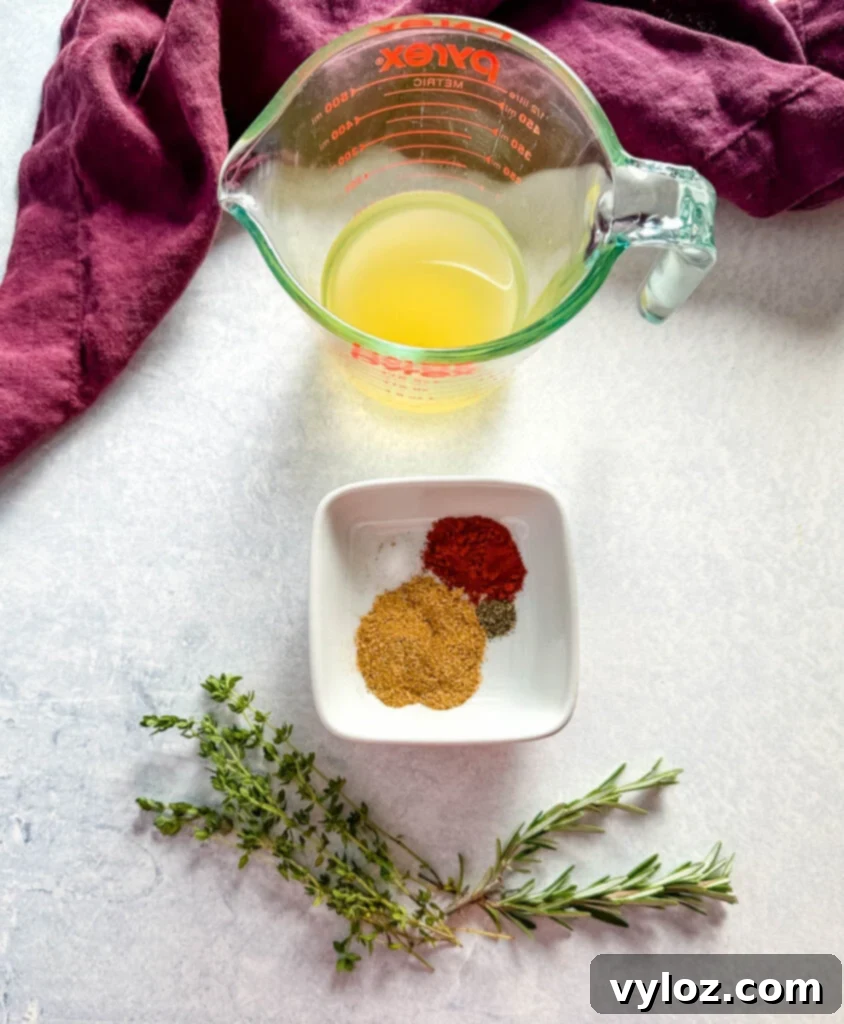Perfect Slow Cooker Cornish Hens 4 broth in a glass cup and spices in a white bowl