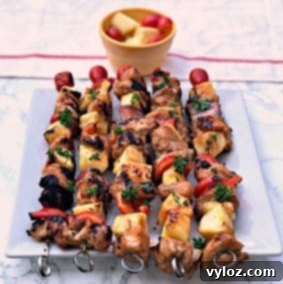 Aloha Grilled Chicken and Pineapple Skewers 8 5 Hawaiian pineapple chicken skewers served on a white square plate