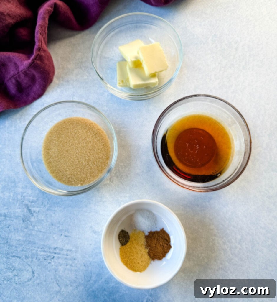 Bowls containing key glaze ingredients: butter, brown sugar, maple syrup, ground cinnamon, and garlic powder.