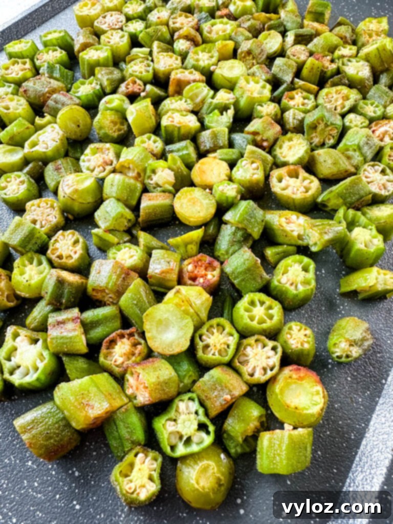 Crispy roasted okra on a baking sheet, ready to serve