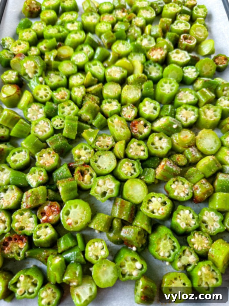 Crispy, golden-brown roasted okra served on a sheet pan
