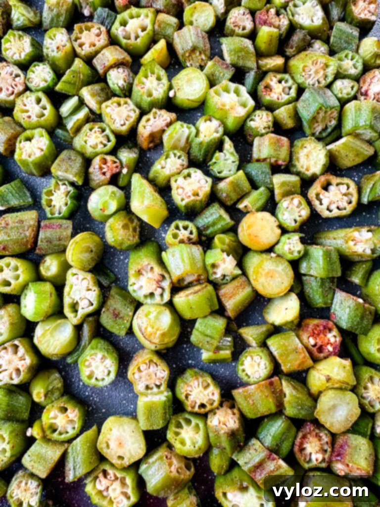 A generous serving of crispy roasted okra on a white platter