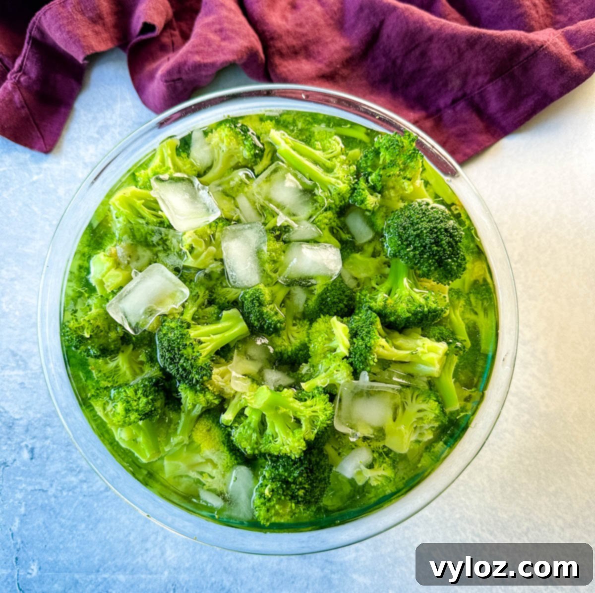 blanched broccoli in a glass bowl with ice