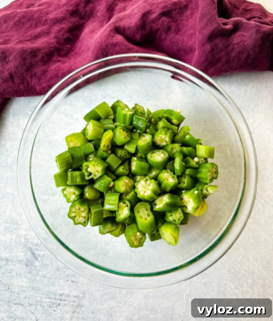 Fresh okra pods in a clear glass bowl
