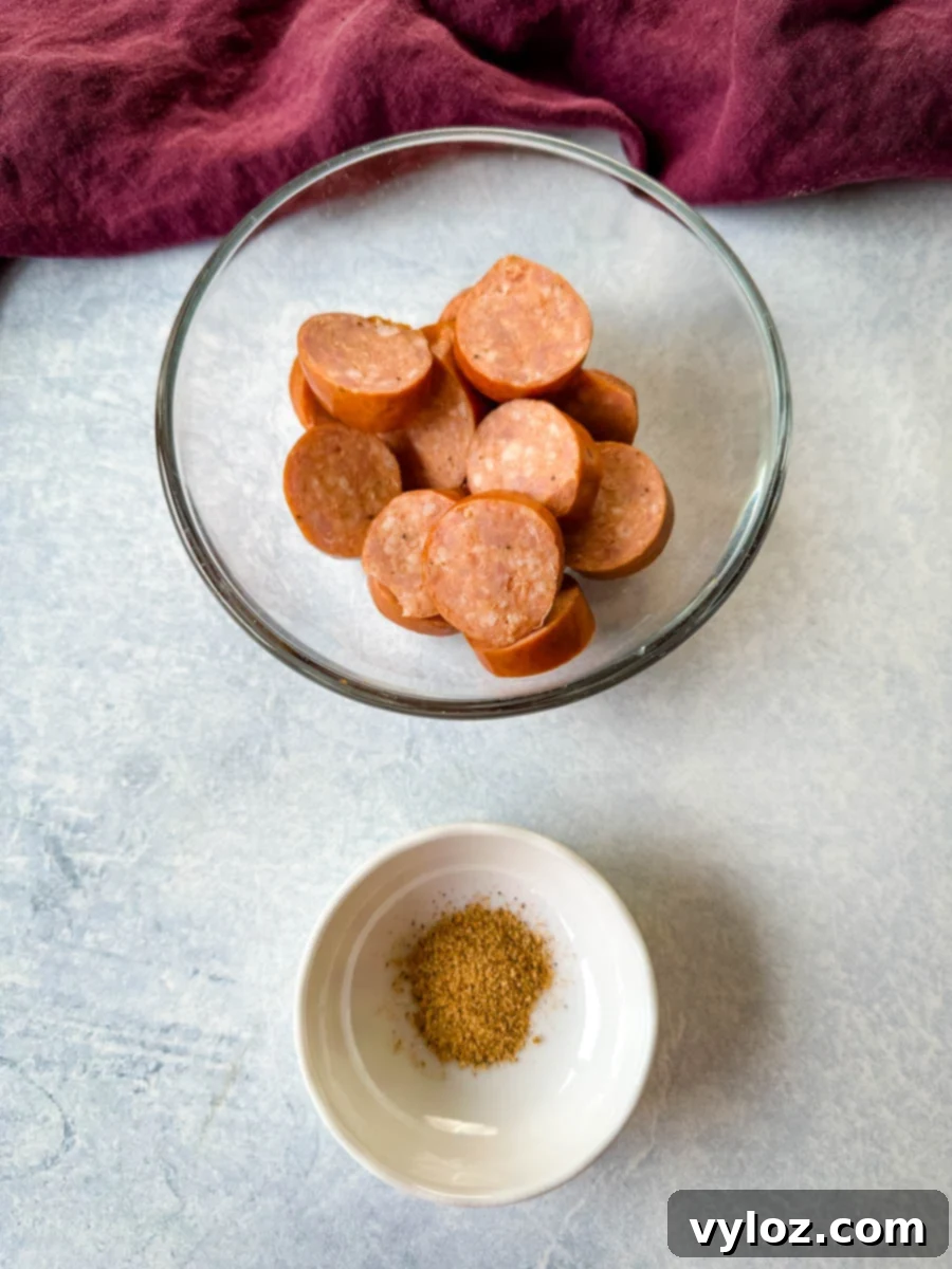 Sliced Andouille sausage and a bowl of Creole seasoning