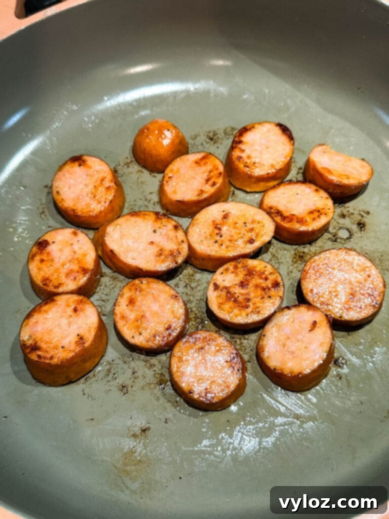 Cooked Andouille sausage in a cast iron skillet