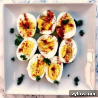 Sliced hard boiled eggs on a square plate