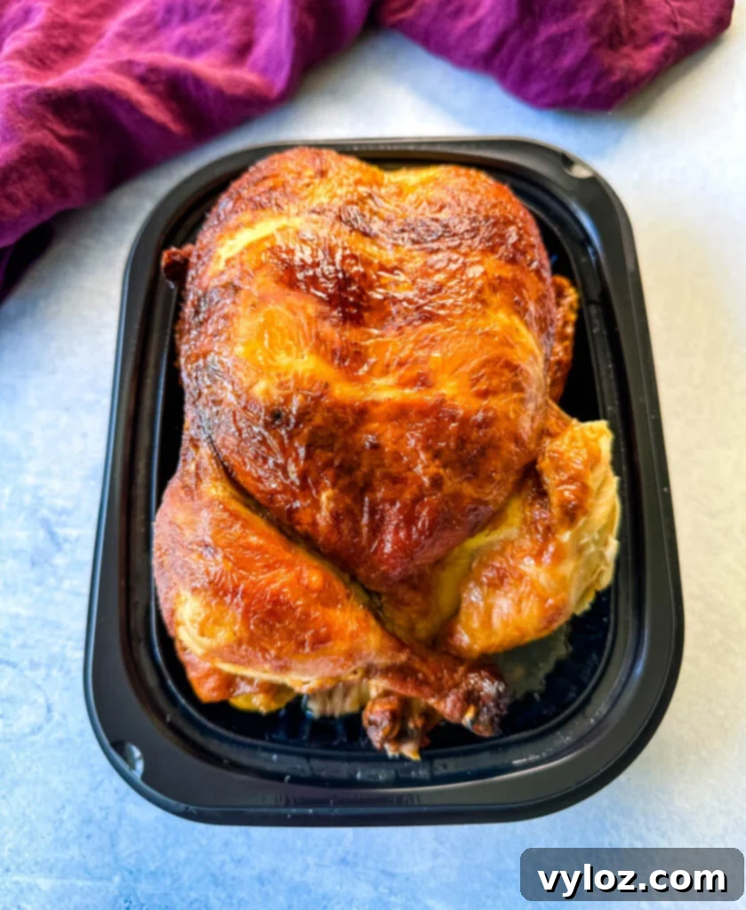 cooked rotisserie chicken in black packaging