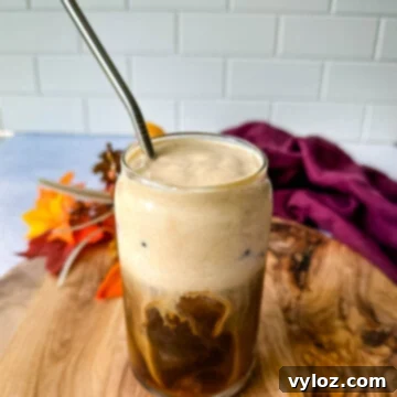 Guilt-Free Pumpkin Spice Cold Brew 12 pumpkin cream cold brew coffee in a glass cup with a straw