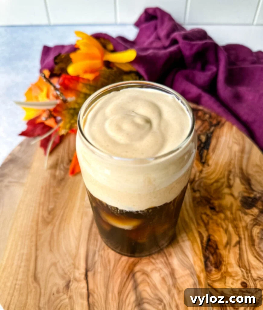 Guilt-Free Pumpkin Spice Cold Brew 10 pumpkin cream cold brew coffee in a glass cup with a straw