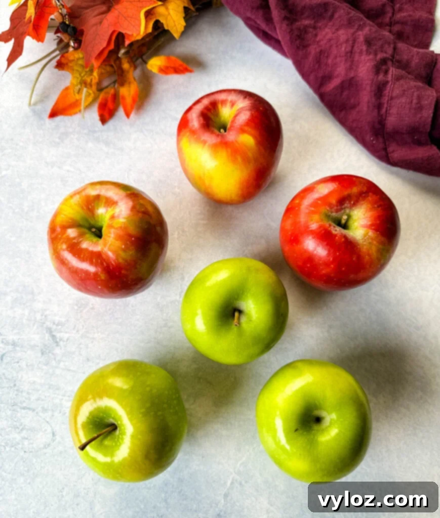 Granny smith and honeycrisp apples on a flat surface