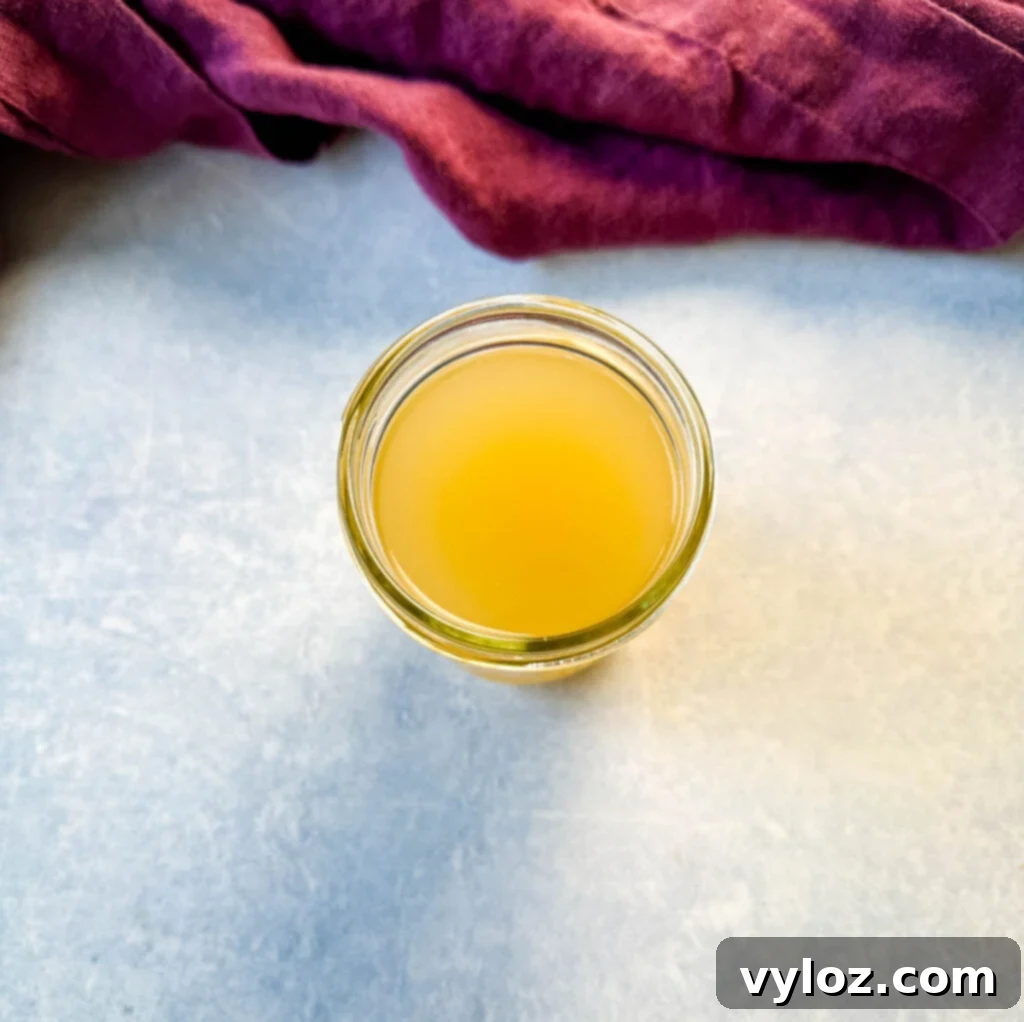 Tender Slow Cooker Duck 4 chicken broth in a measuring cup