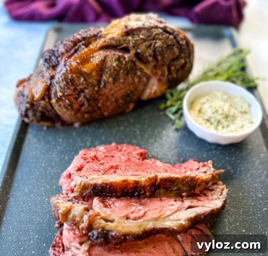 Bone-in or Boneless Garlic Butter Prime Rib 15 garlic herb butter roasted prime rib sliced on a sheet pan with horseradish