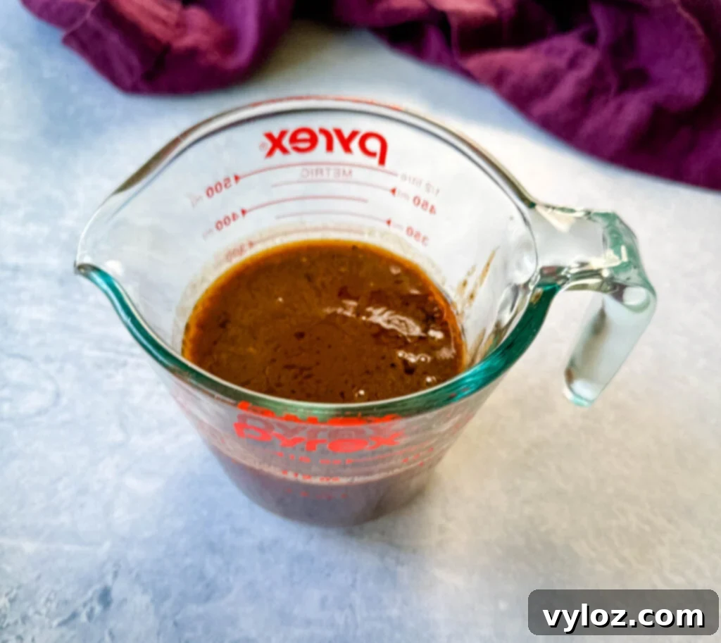 prime rib au jus gravy in a glass measuring cup