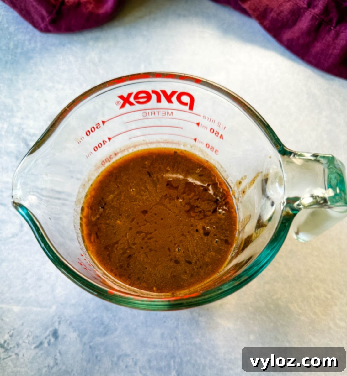 prime rib au jus gravy in a glass measuring cup