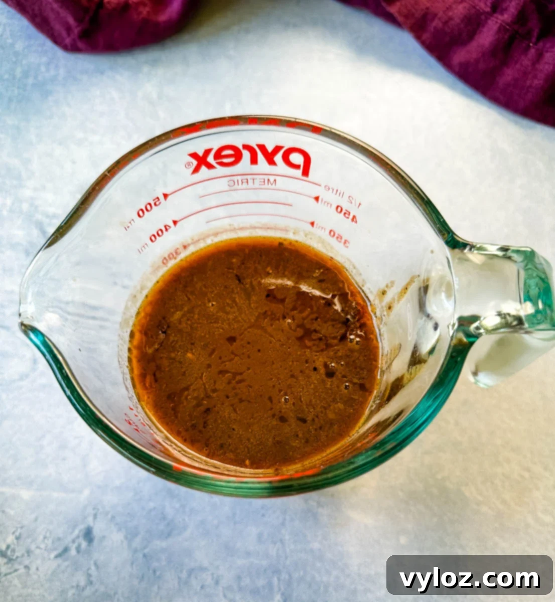 prime rib au jus gravy in a glass measuring cup