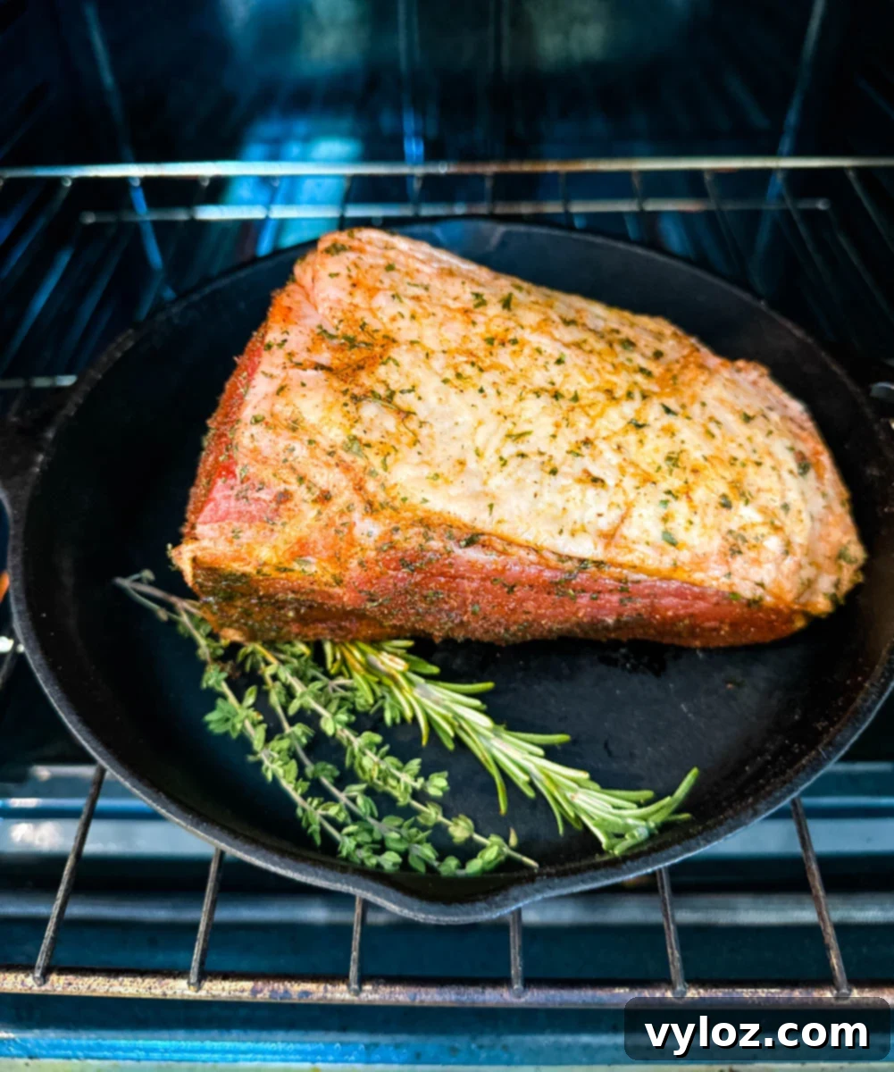 eye of round roast beef in a cast iron skillet in the oven