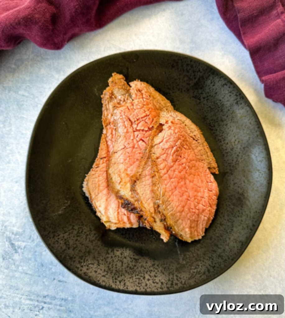 sliced roast beef on a black plate