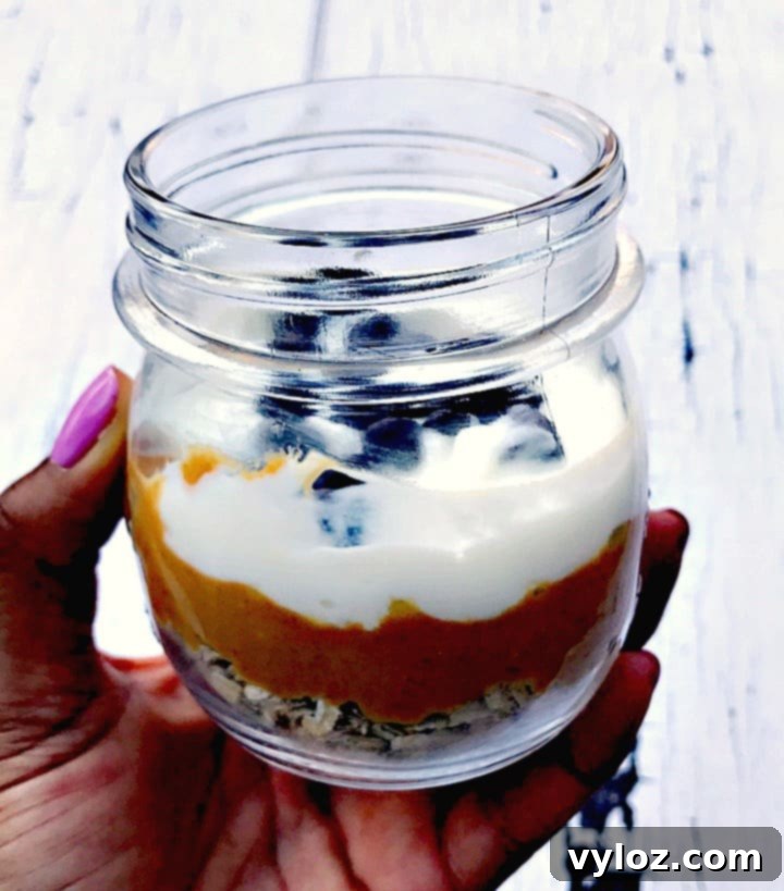 A close-up shot of a single glass jar of Chocolate Chip Cookie Dough Protein Overnight Oats, showcasing its inviting texture.