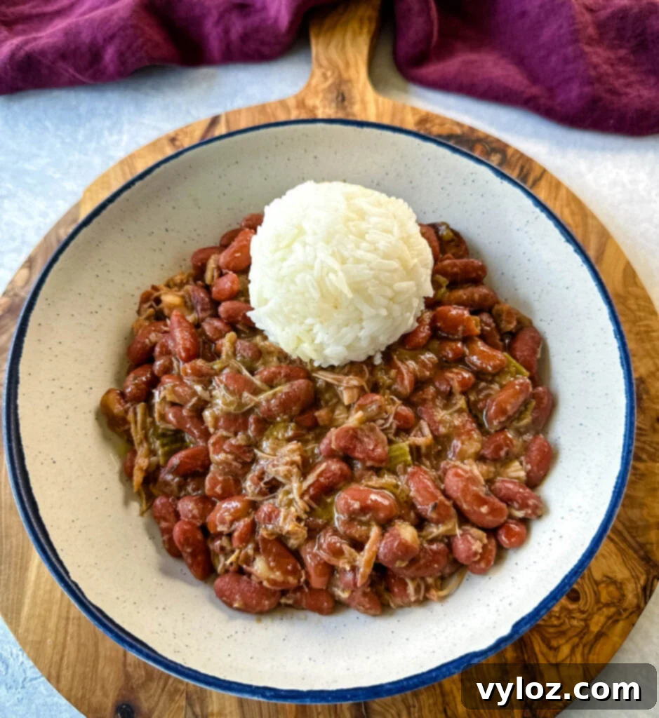 A hearty bowl of Southern Cajun red beans and rice with tender smoked turkey, garnished with fresh parsley, ready to be enjoyed.