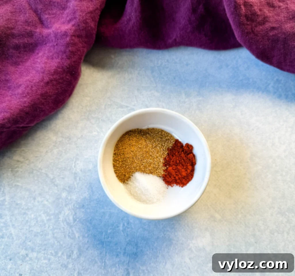 Creole seasoning, smoked paprika, and salt in a white bowl