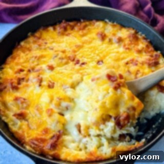 Hash brown casserole with bacon and cheese in a cast iron skillet, a perfect breakfast or brunch dish.