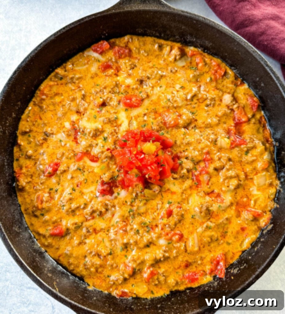 Rotel dip with ground beef in a cast iron skillet