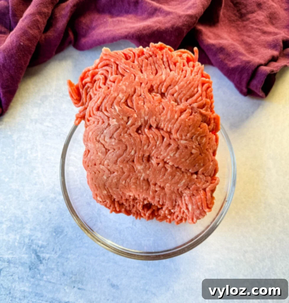 Fresh, raw ground beef in a glass bowl, ready for seasoning