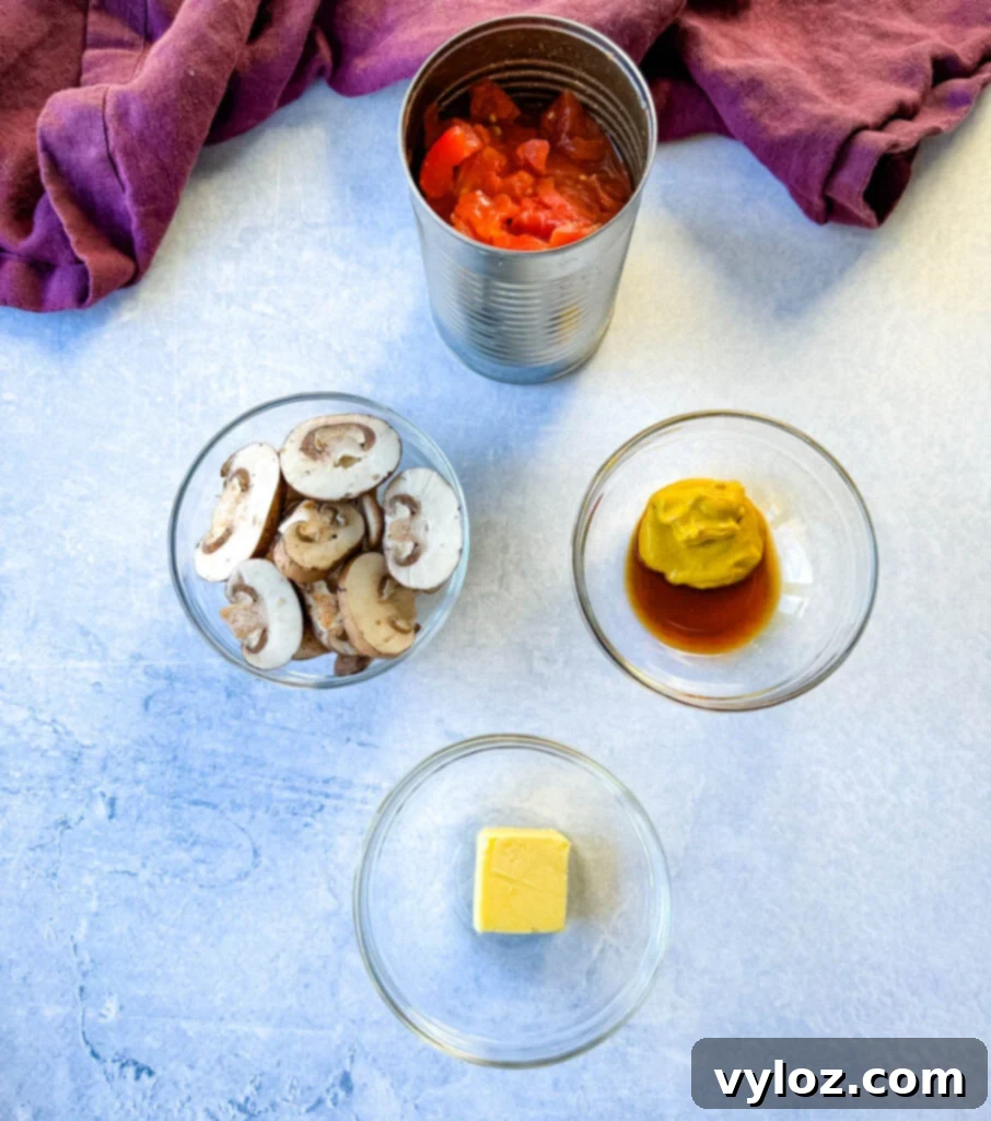 A collection of slider ingredients: canned diced tomatoes, fresh sliced mushrooms, mustard, Worcestershire sauce, and butter in separate glass bowls