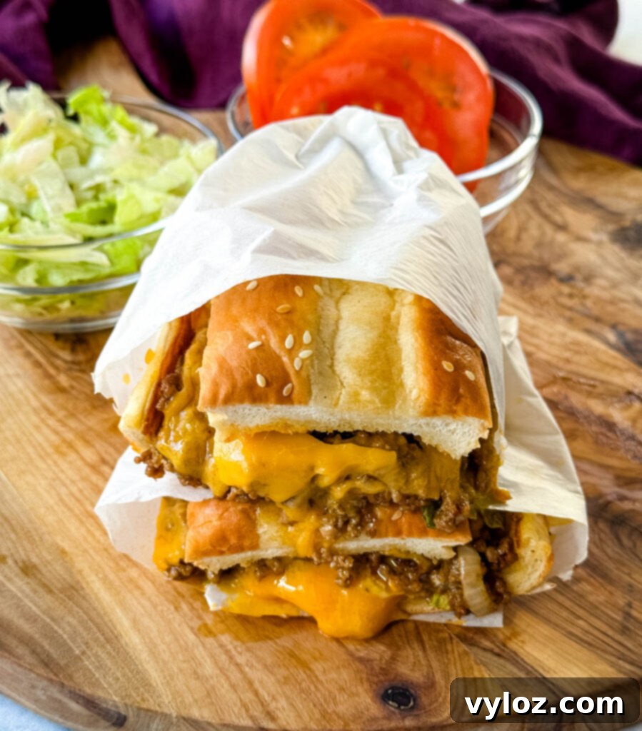 chopped cheese sandwich with lettuce and tomatoes in a wrapper