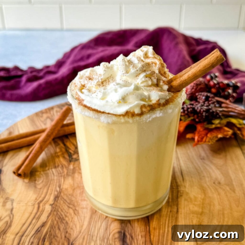 spiked eggnog with liquor, cinnamon, and whipped cream on a flat surface