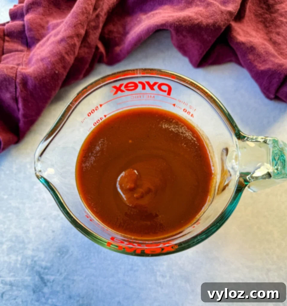 Sweet and Sticky BBQ Little Smokies 4 BBQ sauce in a glass cup