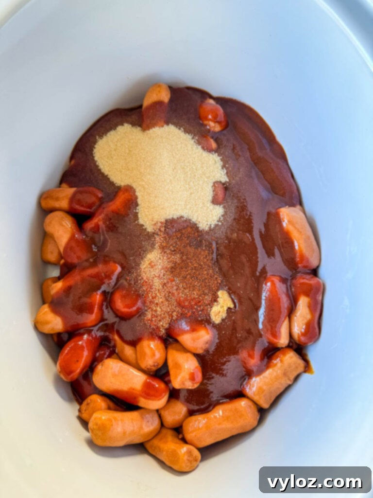 Sweet and Sticky BBQ Little Smokies 7 little smokies in a slow cooker Crockpot with BBQ sauce, brown sugar, chili powder, garlic powder, and smoked paprika