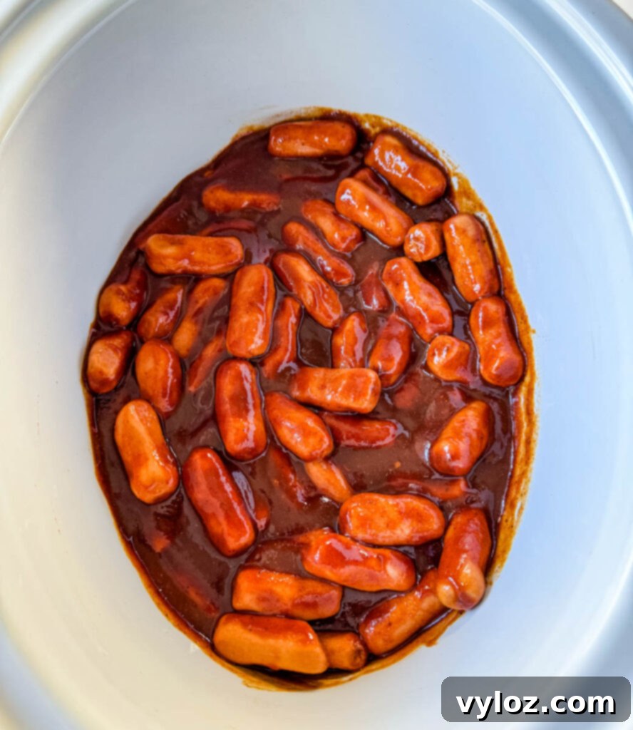 Sweet and Sticky BBQ Little Smokies 8 little smokies in a slow cooker Crockpot with BBQ sauce, brown sugar, chili powder, garlic powder, and smoked paprika