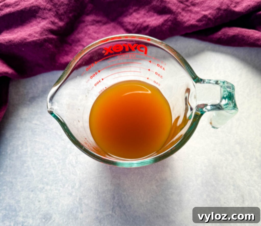 Melt-in-Your-Mouth Slow Cooker Beef Roast 4 beef broth in a glass measuring group